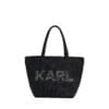 Stylish woman carrying Karl Lagerfeld Paris Signature Canvas Tote bag in a neutral color, showcasing the double top handle and spacious design.