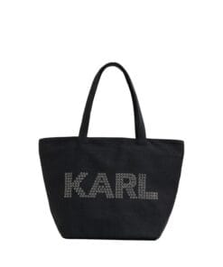 Stylish woman carrying Karl Lagerfeld Paris Signature Canvas Tote bag in a neutral color, showcasing the double top handle and spacious design.