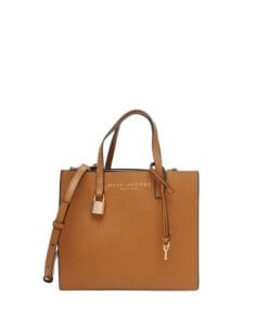 Luxurious brown coated leather Marc Jacobs Mini Grind tote bag featuring lock and key charms, displayed against a neutral background.