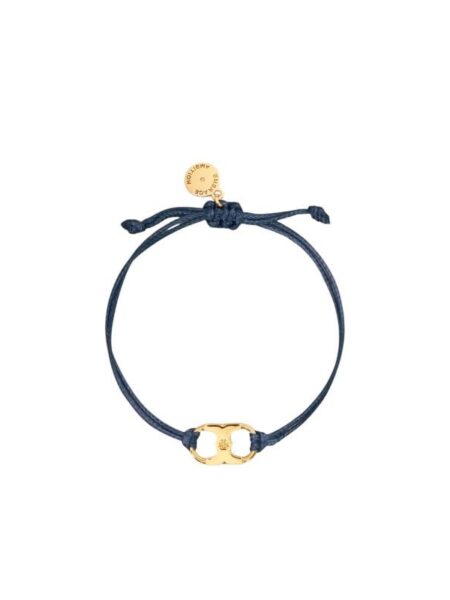 A navy blue cord bracelet with a gold Gemini Link charm by Tory Burch, designed for women's empowerment.