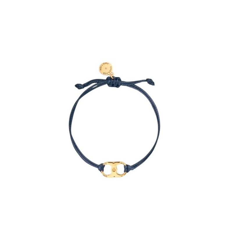 A navy blue cord bracelet with a gold Gemini Link charm by Tory Burch, designed for women's empowerment.