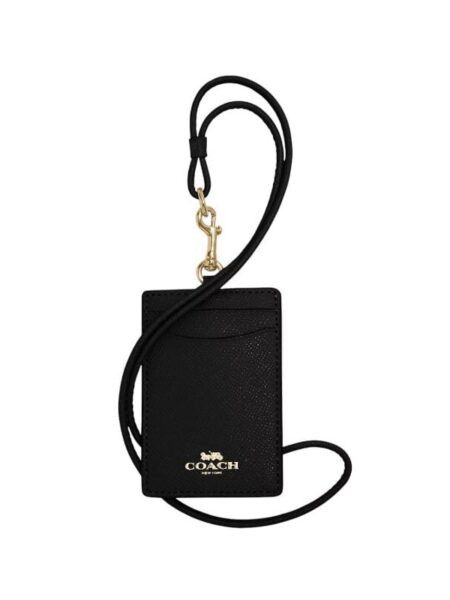 A luxury Coach ID lanyard in black crossgrain leather with gold hardware and two card slots for women in Bahrain.