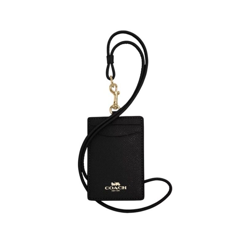 A luxury Coach ID lanyard in black crossgrain leather with gold hardware and two card slots for women in Bahrain.