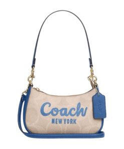 Stylish women carrying the Coach Teri Mini Crossbody Bag in Signature Canvas, perfect for shopping trips in Manama, Bahrain.