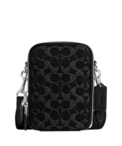 Signature denim crossbody bag for men, Coach Stanton model, ideal for carrying iPhone 16 Pro Max and card case in Bahrain.