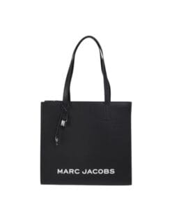 Structured black leather Marc Jacobs Grind tote bag featuring bold logo and silvertone hardware, perfect for professional women in Bahrain.
