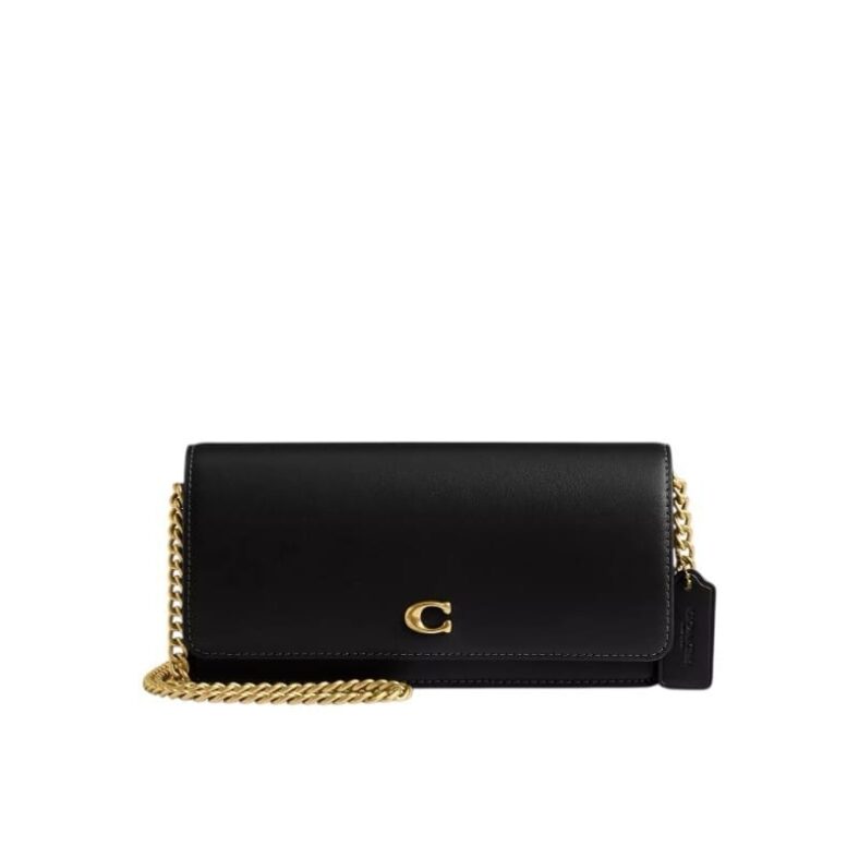 A woman's Coach Evie Long Wallet in black refined calf leather featuring a detachable chain strap and signature hardware.